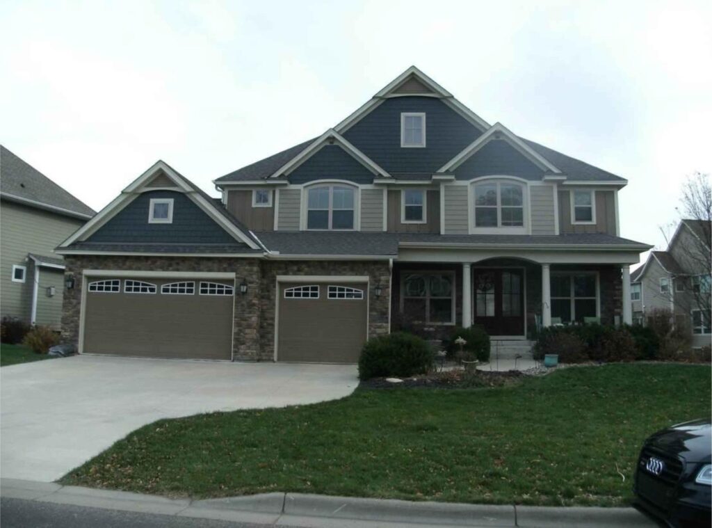 Luxury two-story home with stone and siding exterior in Twin Cities suburb